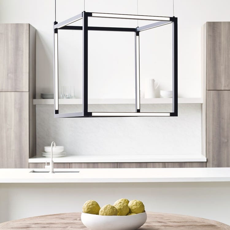 a white kitchen with a white bowl of fruit and a glass cabinet