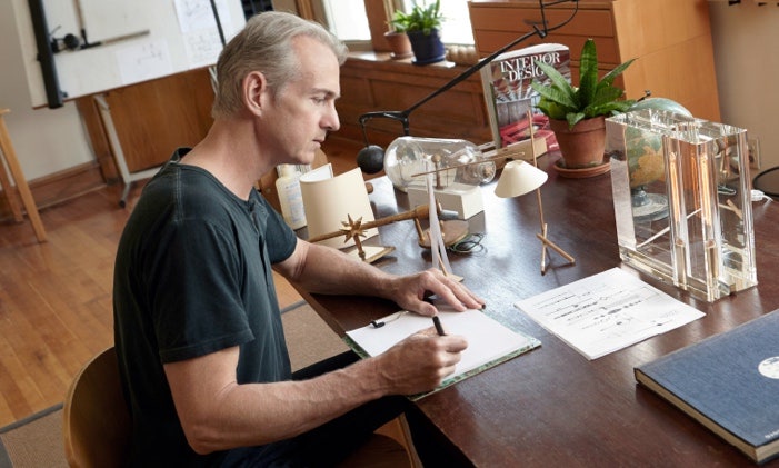 A person writing on a book Description automatically generated