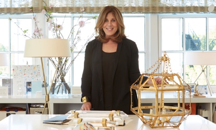 A person standing in front of a table Description automatically generated