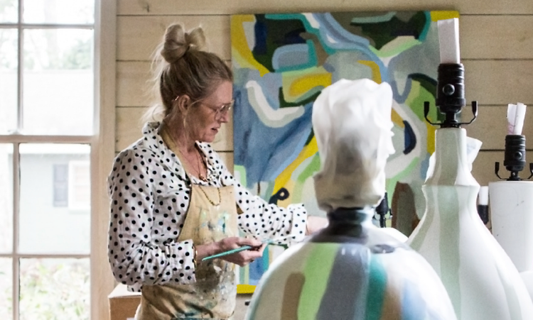 A person painting a mannequin Description automatically generated